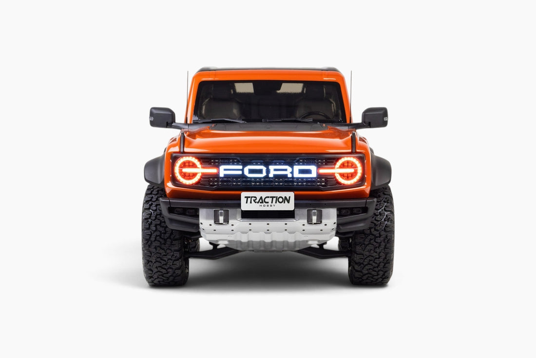 Traction Hobby 1/8 Ford Bronco Raptor in Orange, illuminated front studio view